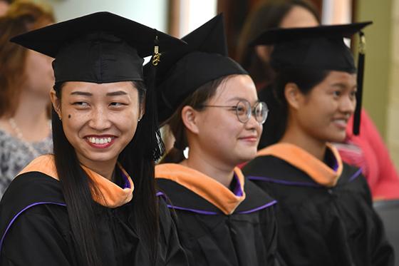 图为三名英国波胆网站留学生在毕业典礼上，他们头戴礼帽，身穿长袍
