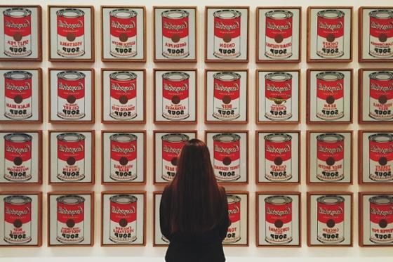 在匹兹堡艺术博物馆，一名女子站在安迪·沃霍尔的汤罐艺术品前. 